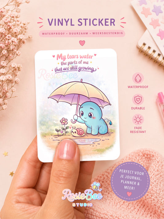 Vinyl sticker van Moji Friend Verdriet met de quote “My Tears Water the Parts of Me That Are Still Growing”. Glossy, waterbestendige sticker voor een journal, planner, laptop of waterfles.
