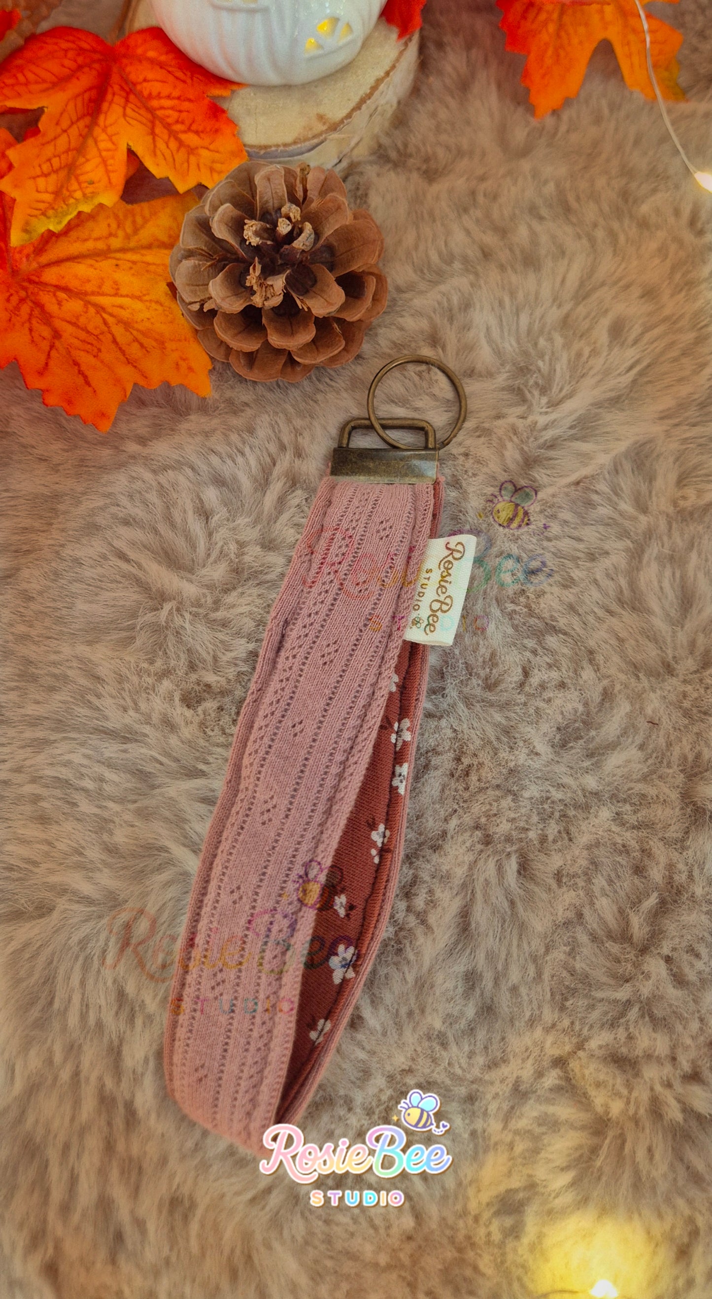 Handgemaakte Quiet Chapters wristlet van RosieBee Studio met oudroze opengewerkte stof, roestkleurige bloemenstof en bronskleurige hardware.