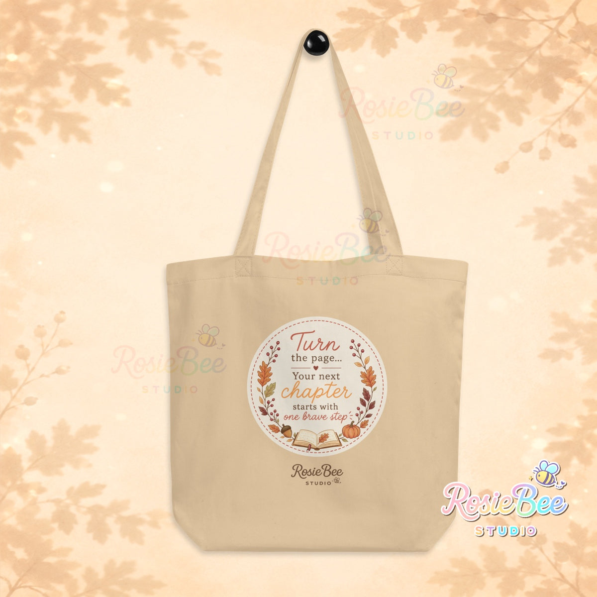 Naturelkleurige A New Chapter tote bag van biologisch katoen met Turn the Page quote, herfstbladeren en open boek van RosieBee Studio.